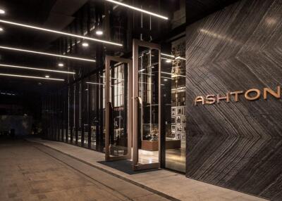 Exterior view of modern building entrance with glass facade and signage