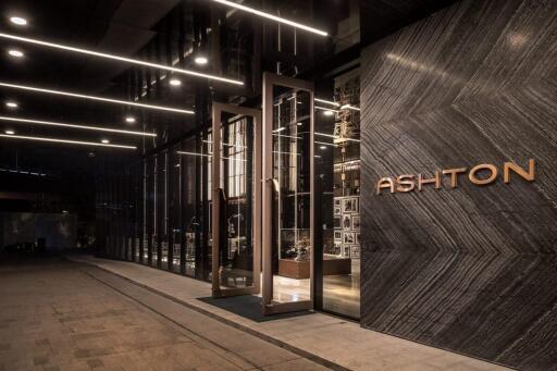 Exterior view of modern building entrance with glass facade and signage