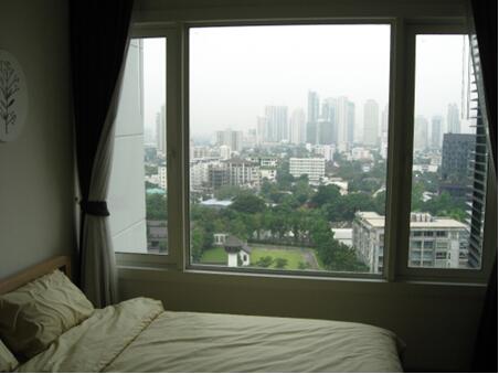 Bedroom with a large window overlooking the cityscape