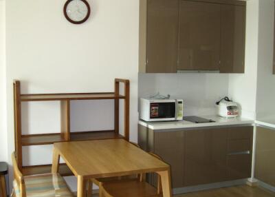 Small kitchen with dining table and appliances