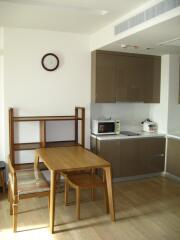 Small kitchen with dining table and appliances