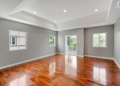 Spacious living room with wooden flooring and ample natural light