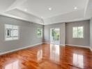 Spacious living room with wooden flooring and ample natural light