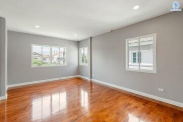 Spacious main living area with wooden flooring and natural light