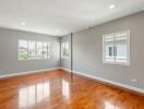 Spacious main living area with wooden flooring and natural light