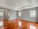 Spacious living room with polished hardwood floors and recessed lighting