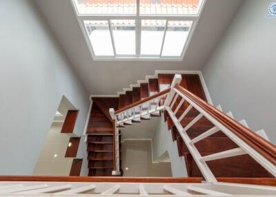 Modern staircase with wooden steps and large window