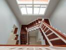 Modern staircase with wooden steps and large window