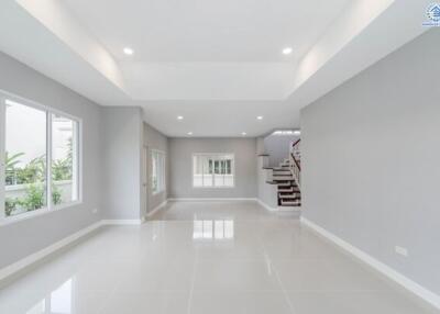 Spacious modern living room with large windows and recessed lighting