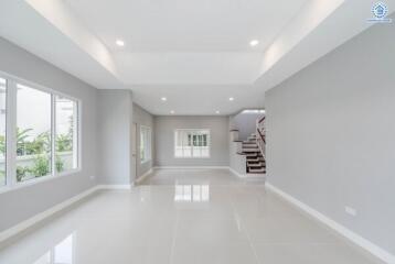 Spacious modern living room with large windows and recessed lighting