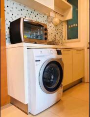 Laundry area with washing machine and an oven