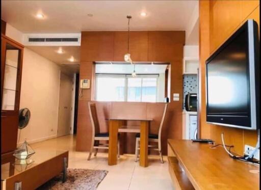 Modern living room with a dining area and mounted TV