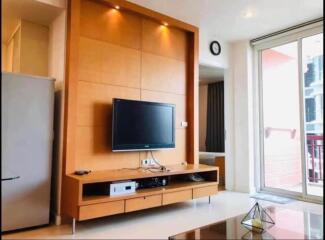 Modern living room with television and sliding glass door