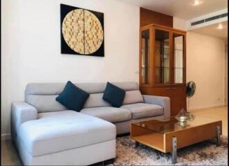 Modern living room with a grey sofa and glass coffee table