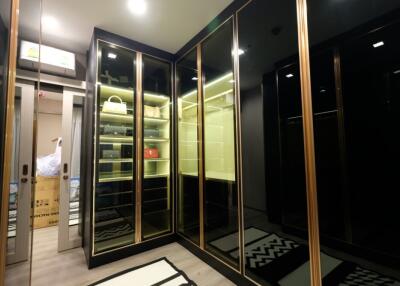 Luxurious walk-in closet with mirrored doors and ample storage