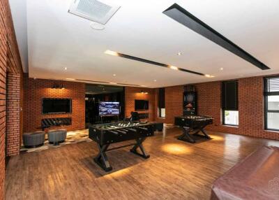 Spacious recreational area with foosball tables and lounge seating