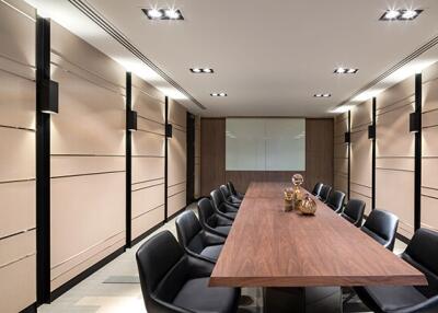 Modern conference room with long wooden table and leather chairs