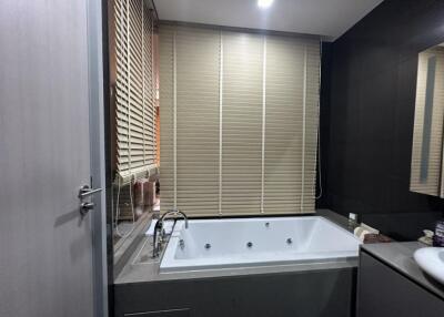 Modern bathroom with bathtub and blinds