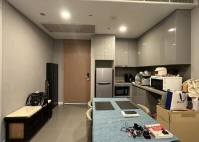 Modern kitchen area with dining table and cabinets