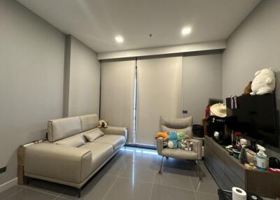 Modern living room with beige sofa and grey armchair