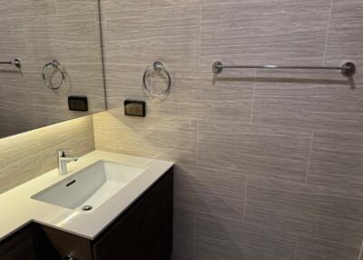 Modern bathroom with sink and wall-mounted towel holder