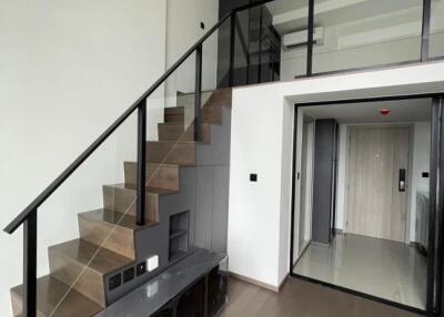 Interior view of a living space with a loft and staircase