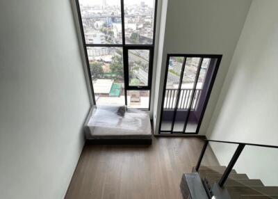 Living area with large window and city view