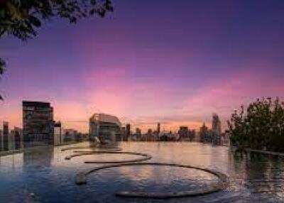 Skyline view from rooftop infinity pool at sunset