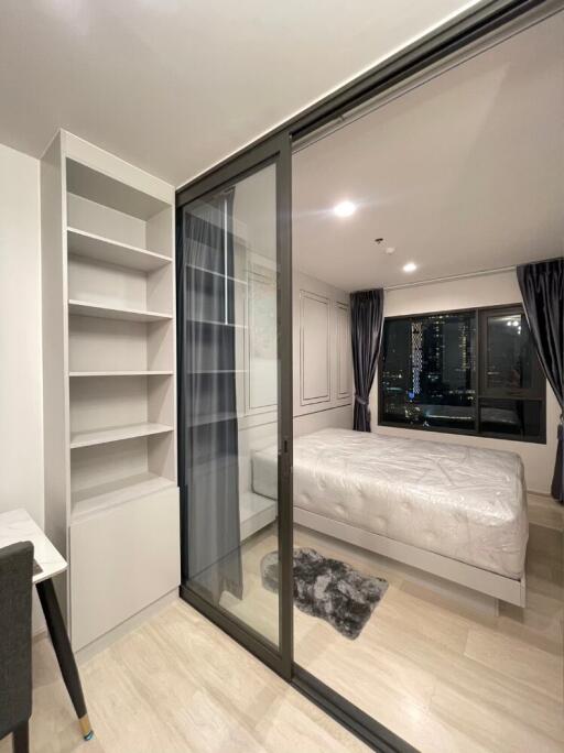 Modern bedroom with large window and sliding glass door