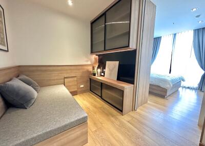 Bedroom with wood accents and a bed in the adjoining room