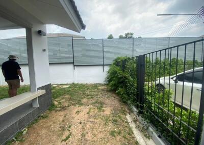 View of the backyard with a small patio and a fence