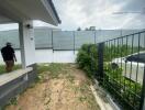 View of the backyard with a small patio and a fence