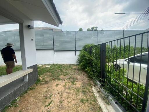 View of the backyard with a small patio and a fence