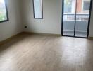 Empty bedroom with large window and sliding glass door