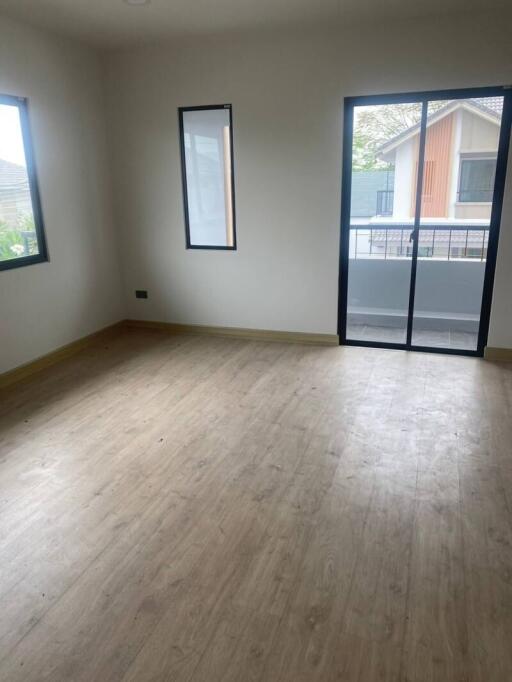 Empty bedroom with large window and sliding glass door