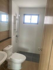 Modern bathroom with white tiles and window