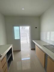 Simple modern kitchen with light cabinets and natural light