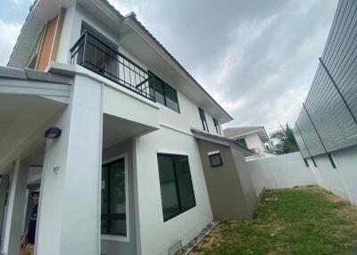 Two-story modern house with white walls and large windows