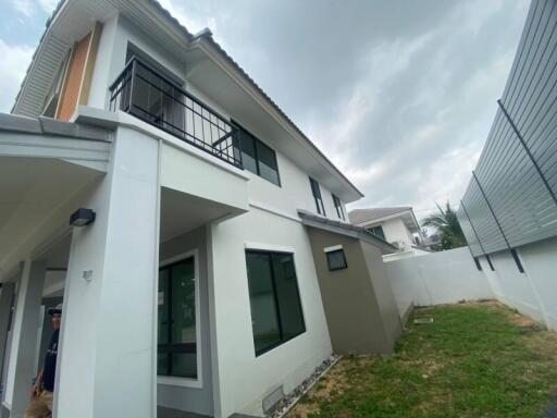 Two-story modern house with white walls and large windows