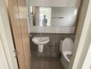 modern bathroom with tiles and a large mirror