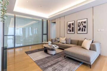 Modern living room with decorative artwork and sectional sofa