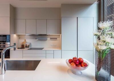 Modern kitchen with white cabinetry and fruit bowl