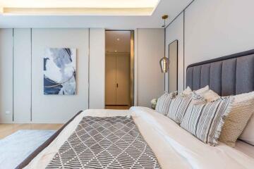 Modern bedroom with artwork and decorative pillows