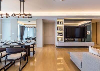 Modern and spacious living area with dining table, TV, and elegant furnishings