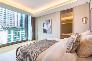 Modern bedroom with large window and city view