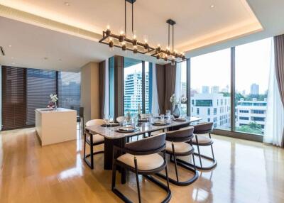 Modern dining room with a view, featuring a long table and large windows.