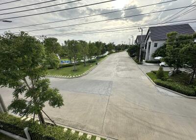 View of a residential street with houses and greenery