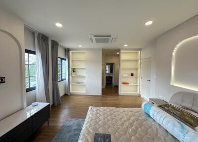 Modern bedroom with bed, shelves, and windows