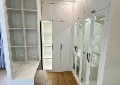 Spacious walk-in closet with built-in shelving and storage