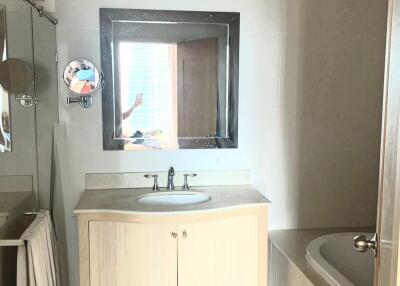 Bathroom with vanity, mirror, and bathtub